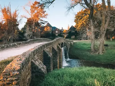 Puente de piedra sobre el arroyo en otoño